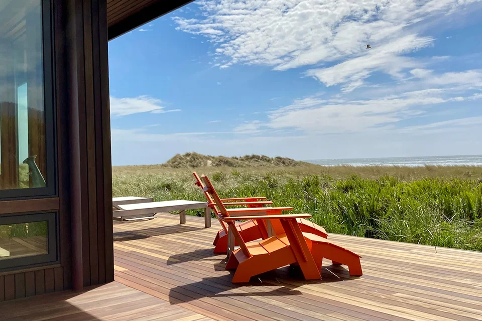 two chairs on a deck overlooking the beach